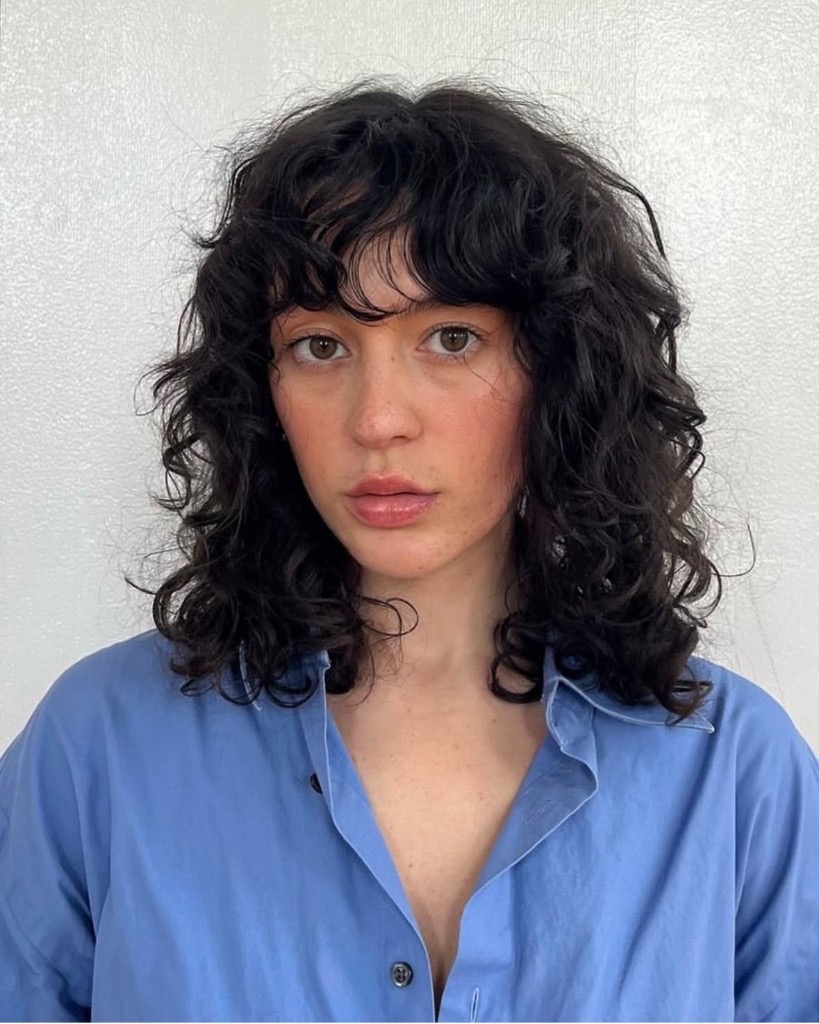 defined curly haircut with volume and structure